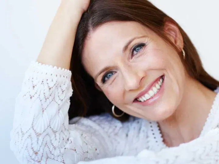 benefits dental implants Melbourne dentist Essendon smiling woman missing teeth replaced