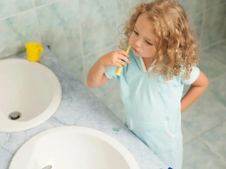 A little girl brushing her teeth