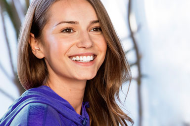 Young woman smiling with her Invisalign clear braces from Essendon dentist Melbourne