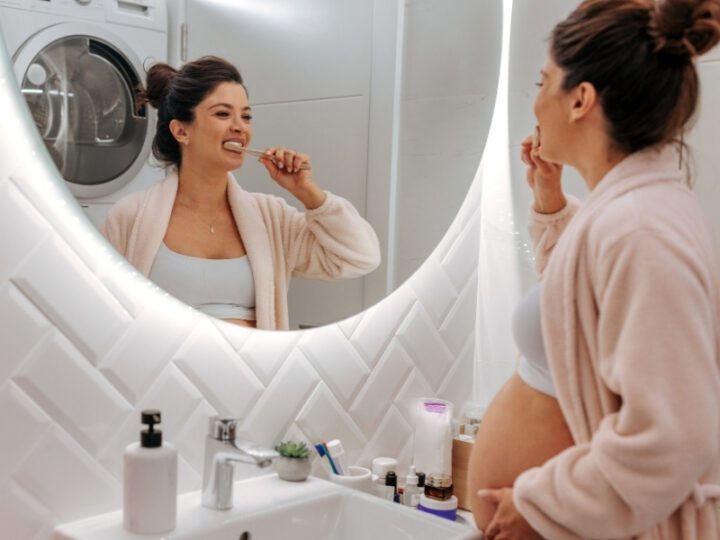 woman brushing her teeth during pregnancy